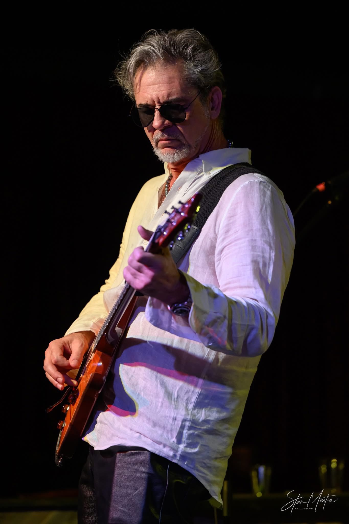 Bob Michaels playing guitar on stage